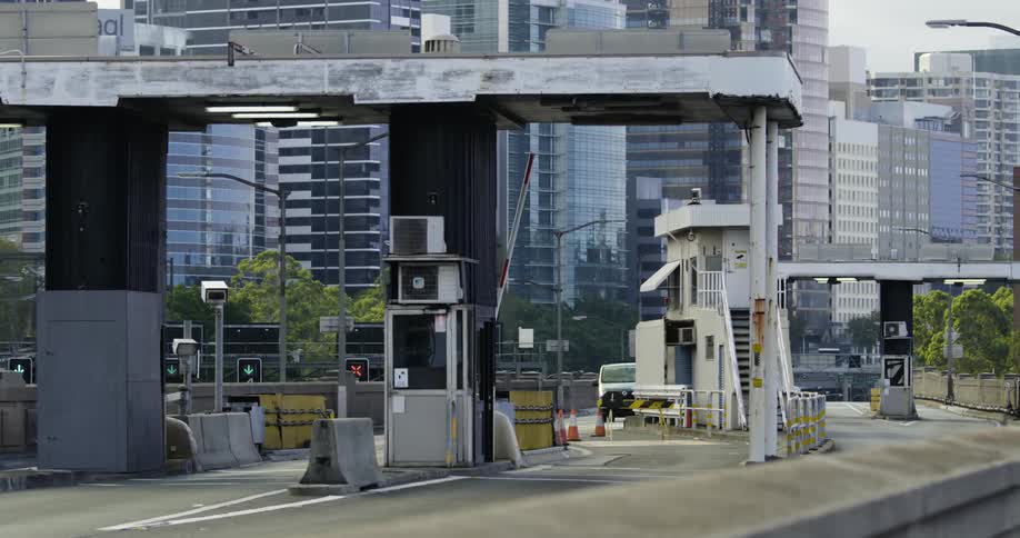 A small amount of traffic passes through a toll booth checkpoint