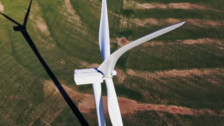 The large windmill sits on the field