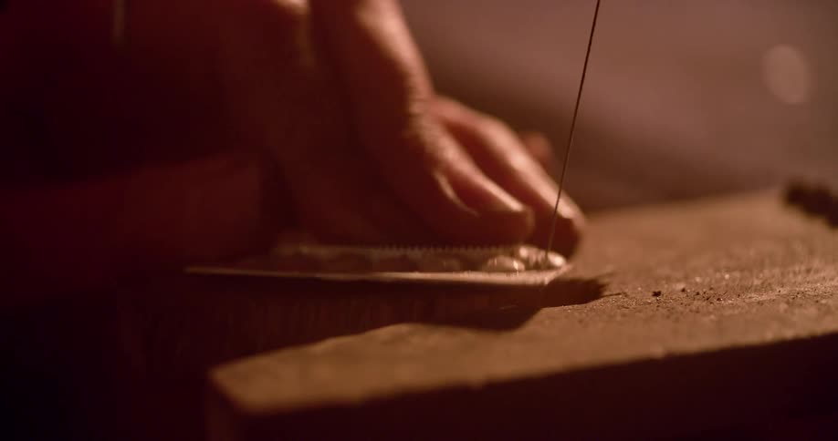 A person is carving an item