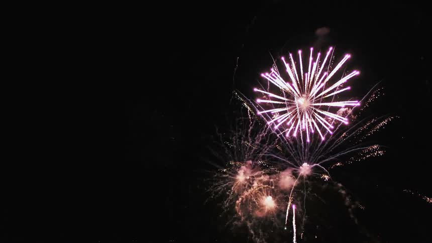 Several fireworks are shot into the sky and explode in bright and vibrant colors