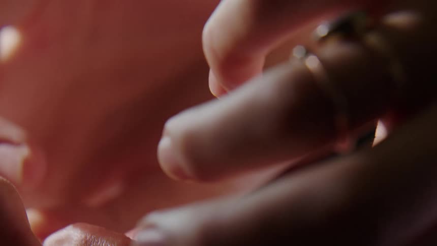 A woman is playing with her necklace