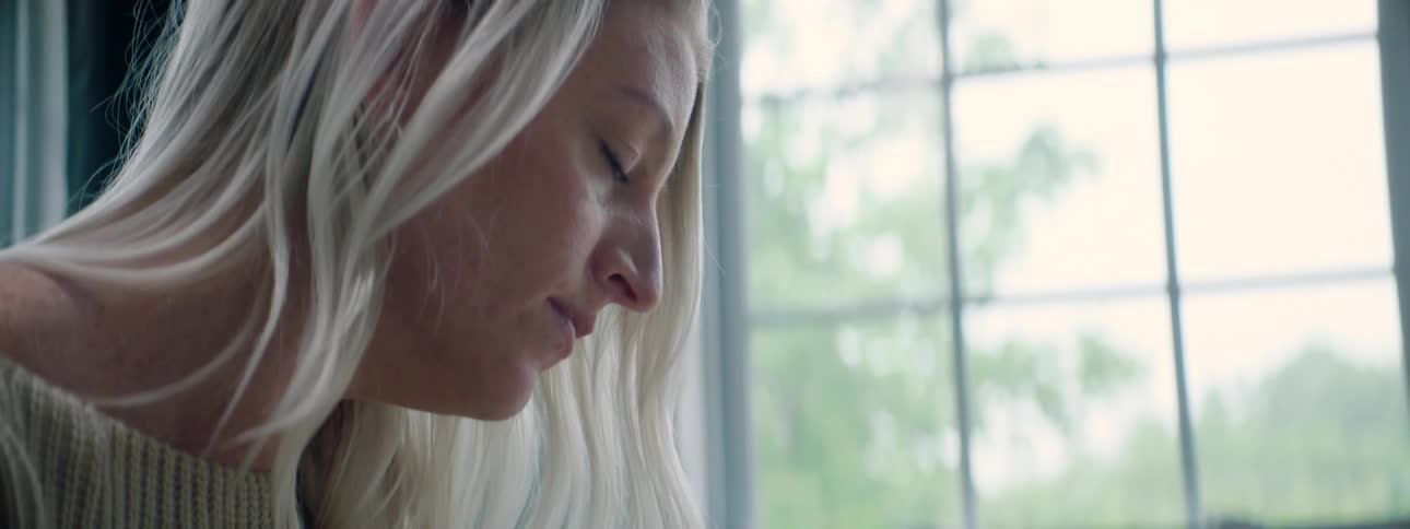 A woman in front of a window at home