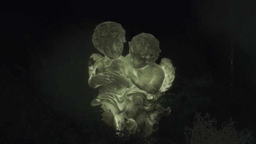 The statue of two children are glowing in the dark