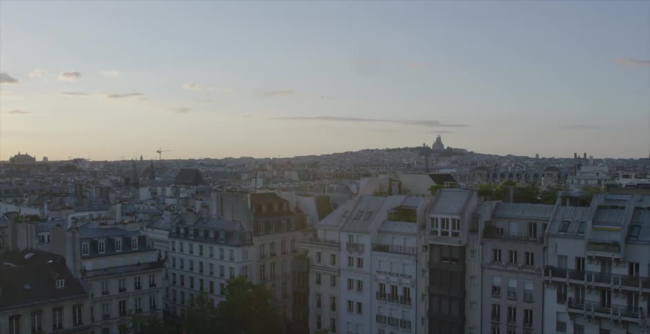 Aerial view of a city full of buildings at sunset