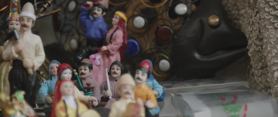 A row of dolls sit on a table