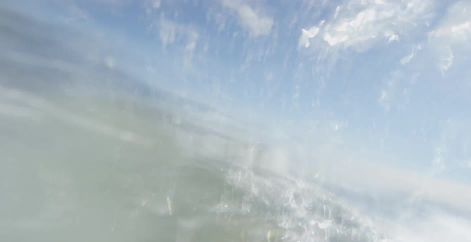 A person is surfing on the ocean water during the day