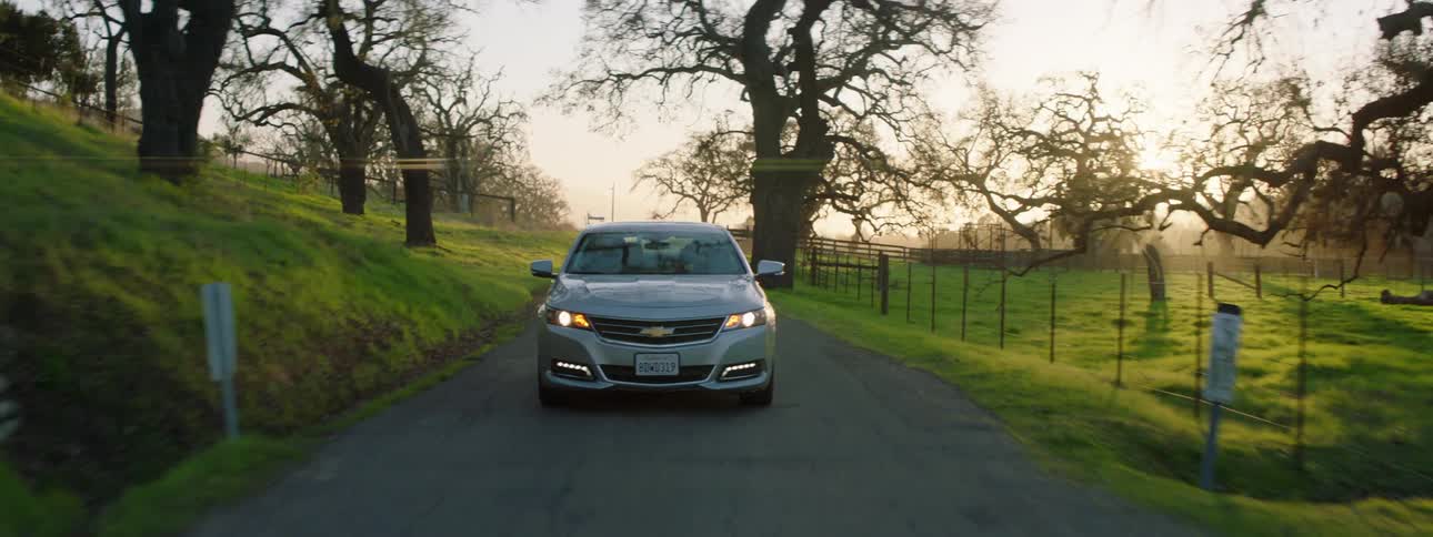 Car driving on a road through the countryside in the fall
