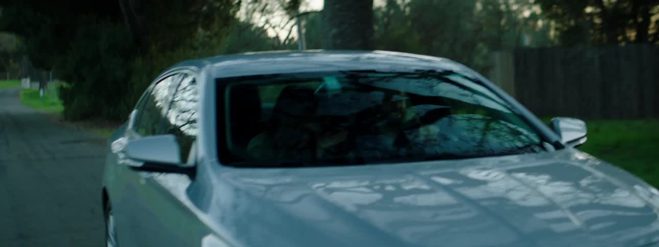 A man driving his car in a rural area