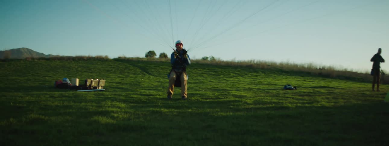 Two men in a field with parachutes