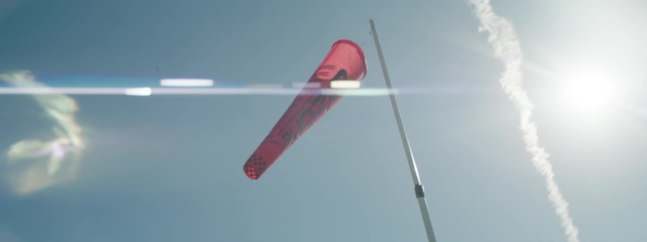 A weather vane blowing in the wind on a sunny day