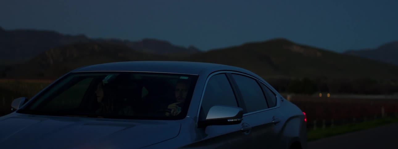 A person is driving a car at night