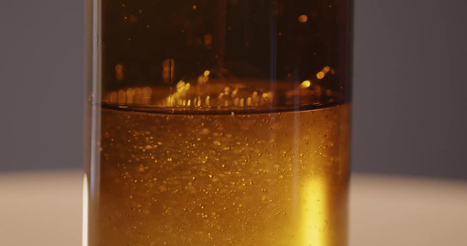 A glass bottle of golden honey