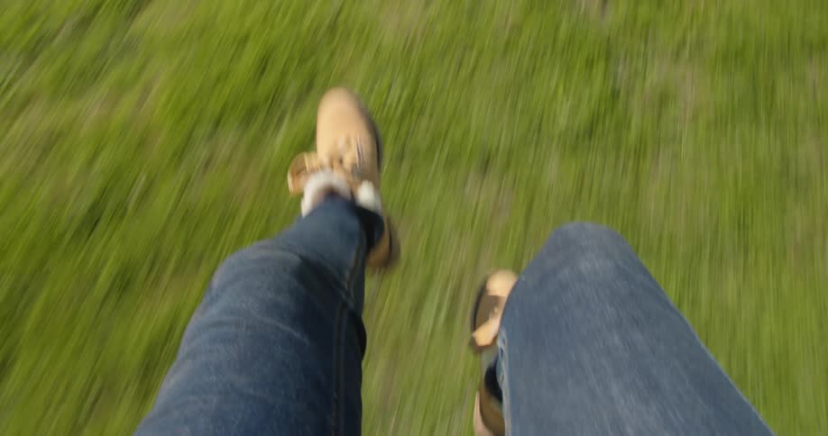 Someone kicks their feet above the ground then lands on the ground and walks unsteadily