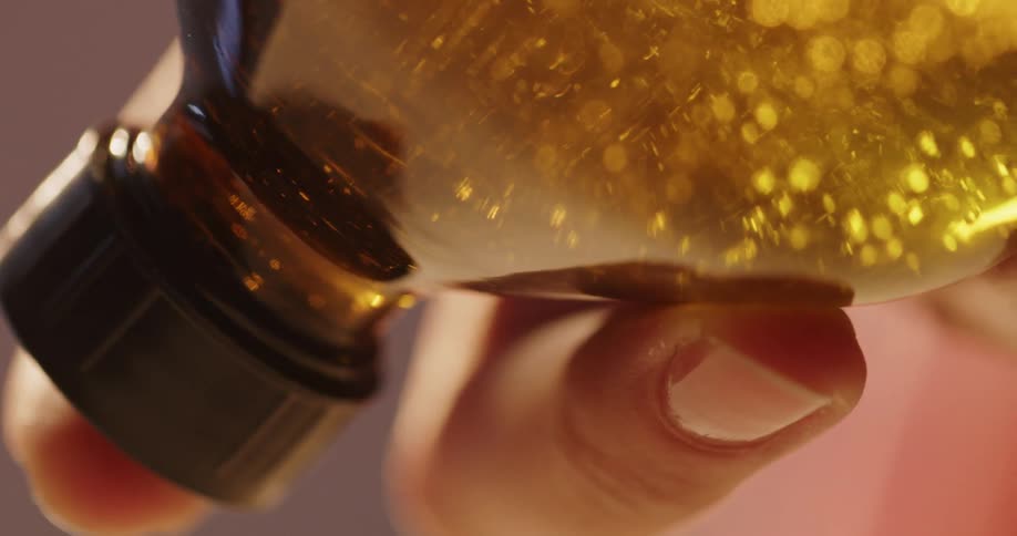 A woman tips a bottle to shake it