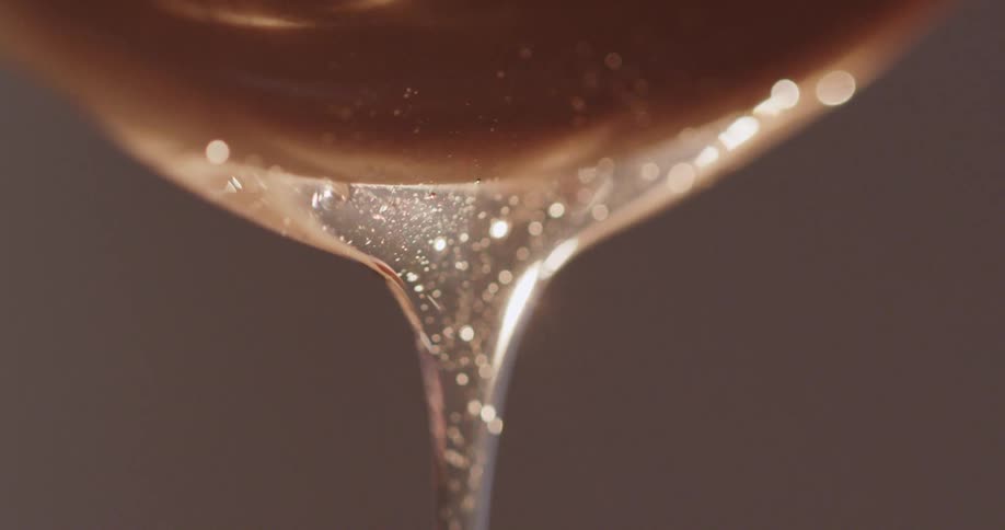 Close up of runny honey being poured