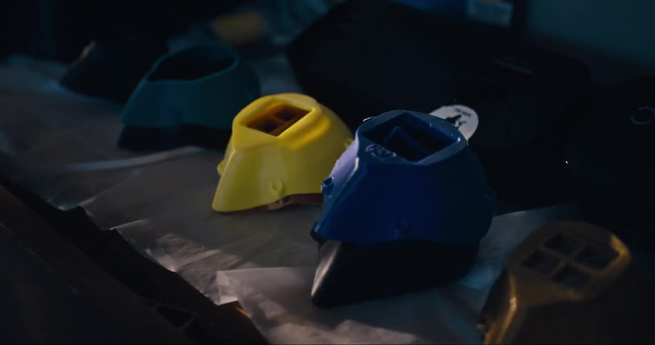 3d printed colorful plastic face mask muzzles in a shelf