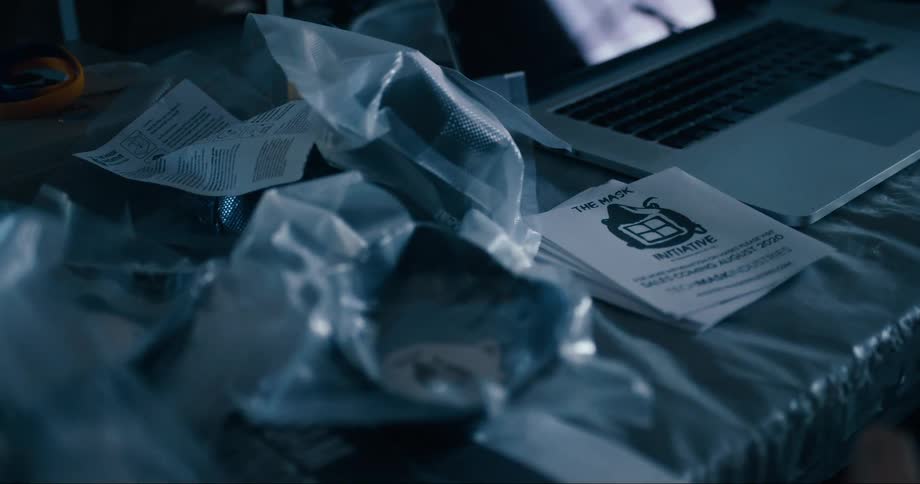Face masks and flyers next to a laptop over a table