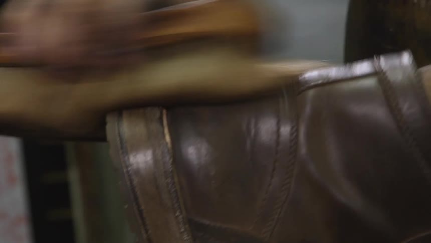 A man using a brush to clean a boot