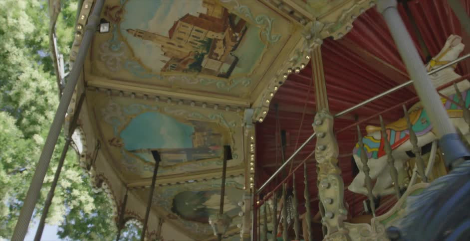 A merry go round turns on a sunny day