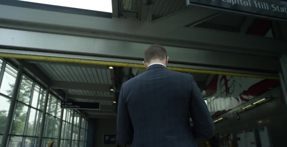 A man is walking through a downtown city