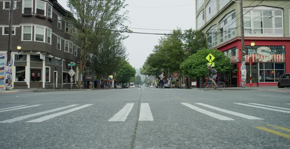 Pedestrians are biking and jogging in a city
