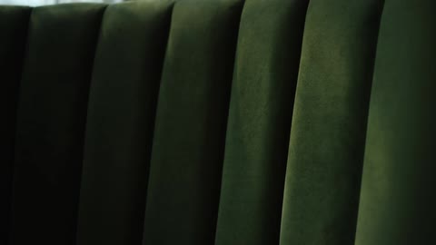 View of the arm of a green sofa in the living room