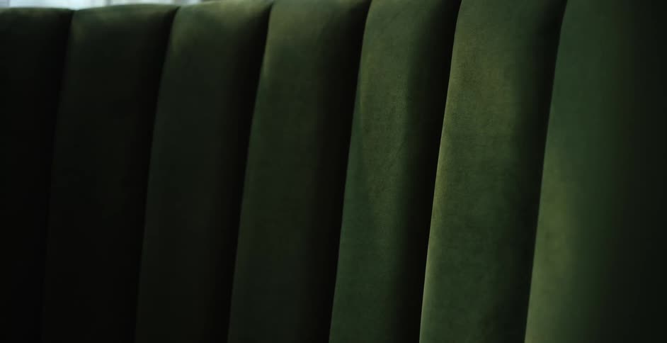 View of the arm of a green sofa in the living room