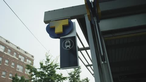 A sign on the building has a train on it