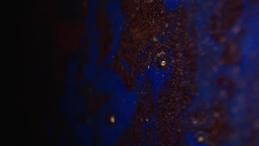 Blue paint spreads in the pink paint