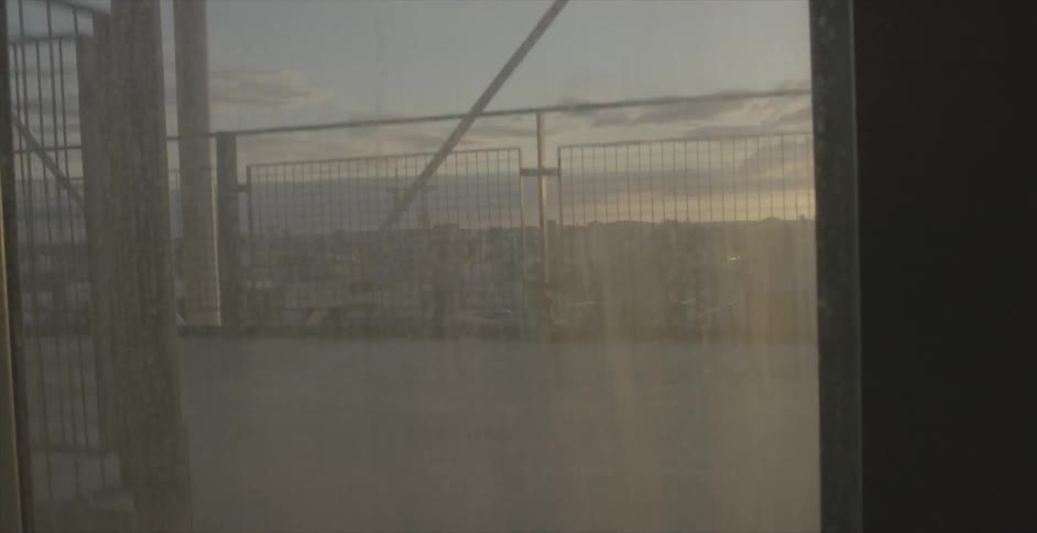 An elevator is moving up a building at sunset