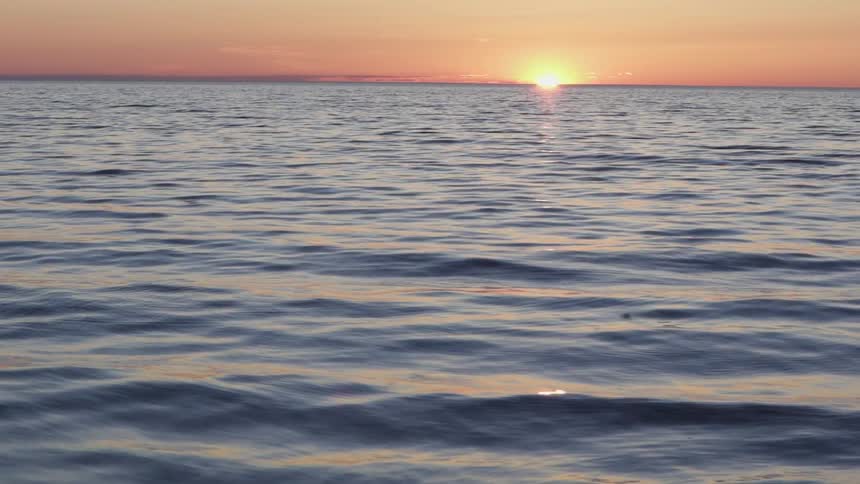 The sun setting on the ocean horizon