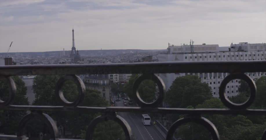 A city behind a railing on a cloudy day