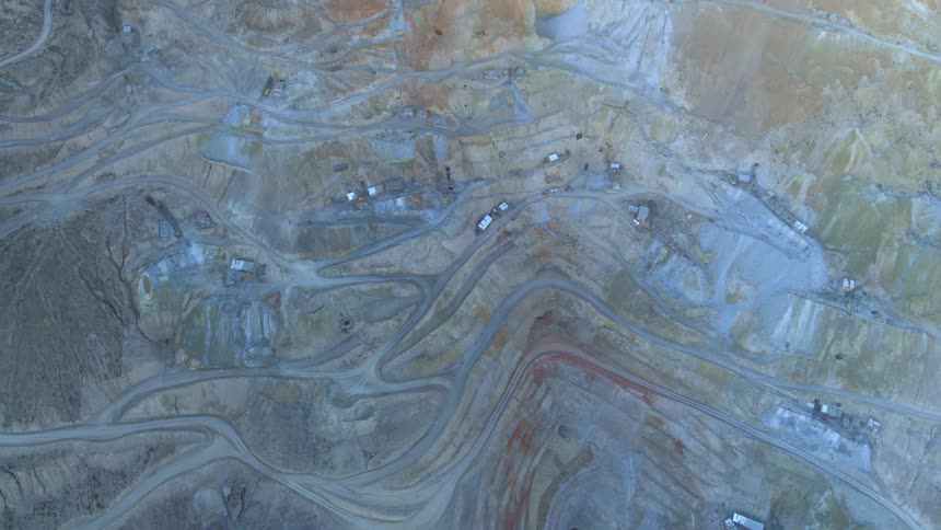 White building rooftops spread out on roads in a barren landscape