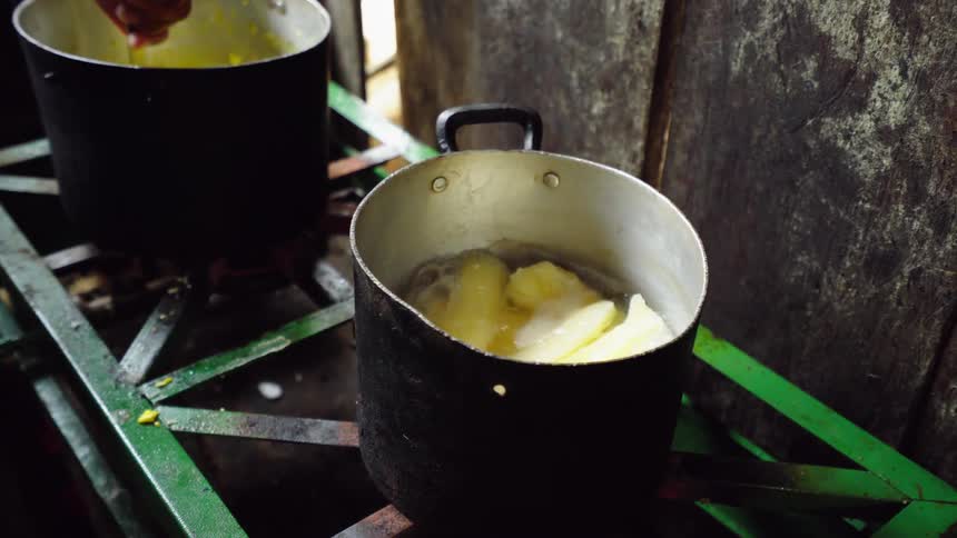 A person is mixing a pot on the stove