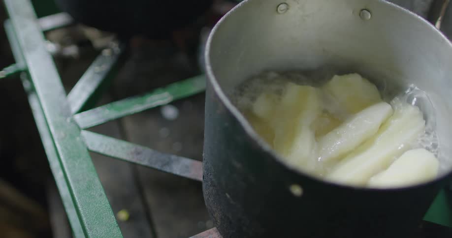 The food boils in the pot on the stove