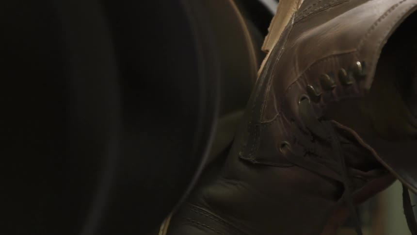 The sole of a boot being sanded down