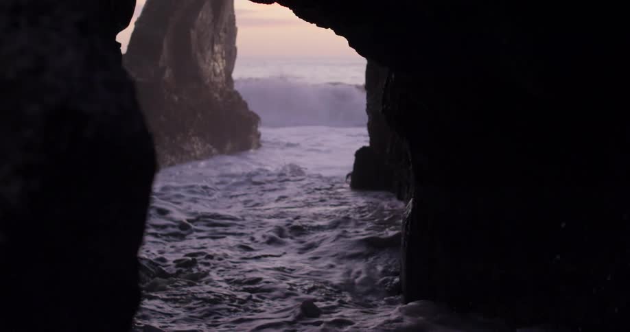 Waves are moving towards the cave outdoors