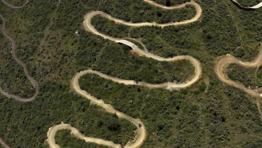 Aerial view of people riding bikes on a track