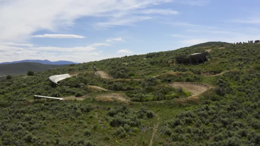 An aerial view of bicyclists riding dirt bikes on a dirt bike course