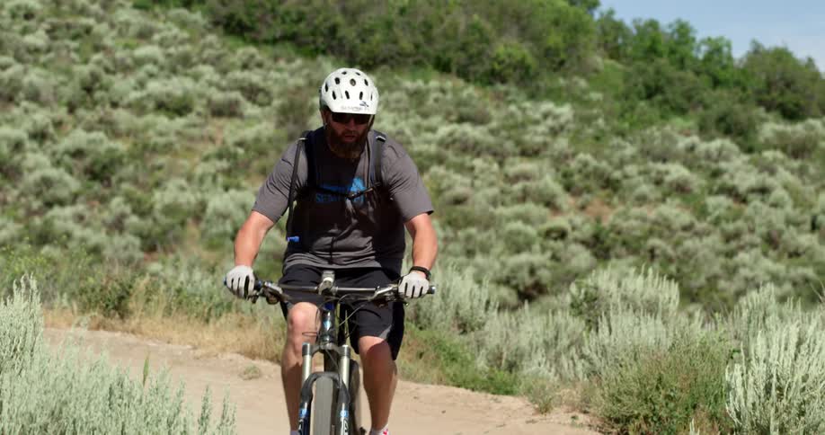 A man biking through the hills