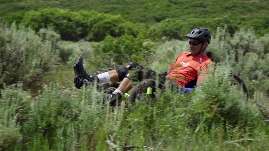 A man is riding a vehicle down the hill