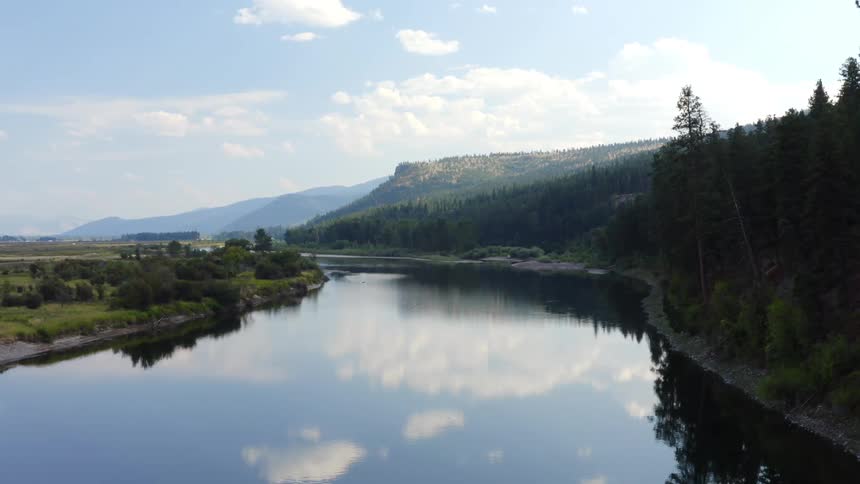 Landscape view of a calm lake with trees on the shore