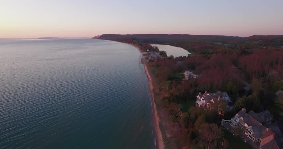 Aerial view of a coast with a few large houses by the water