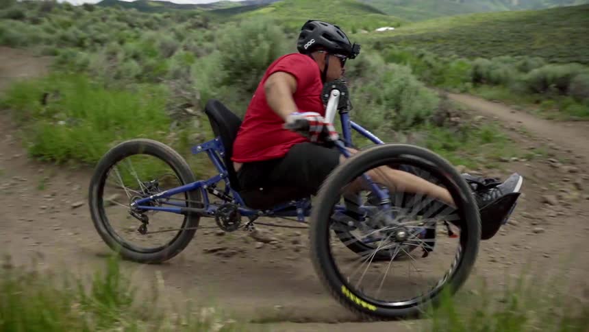 A man rides a wheeled vehicle down the track