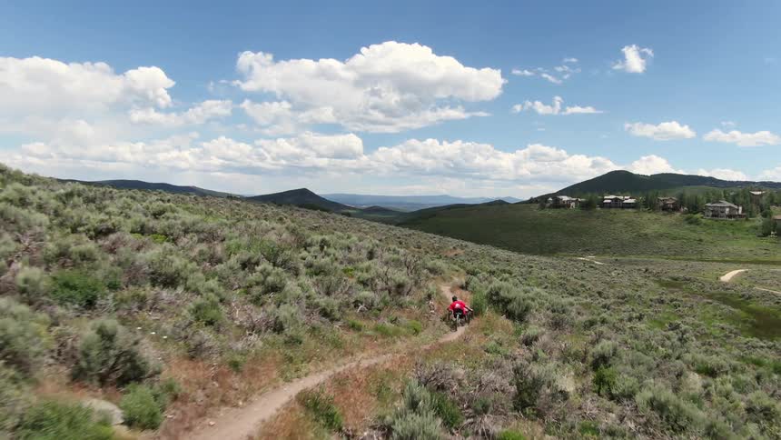 A person is on a vehicle rolling over the hills