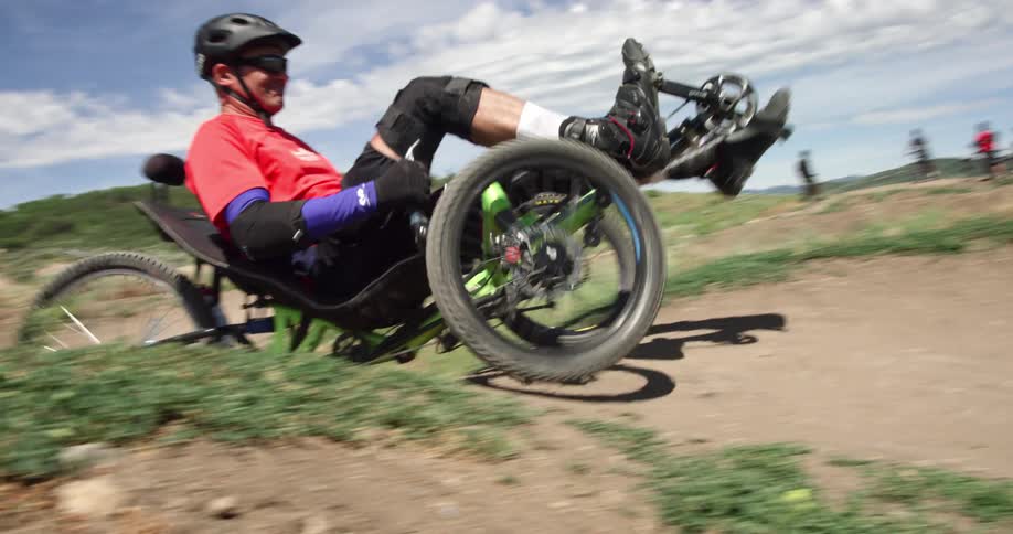 A man rides around in a vehicle over the hills