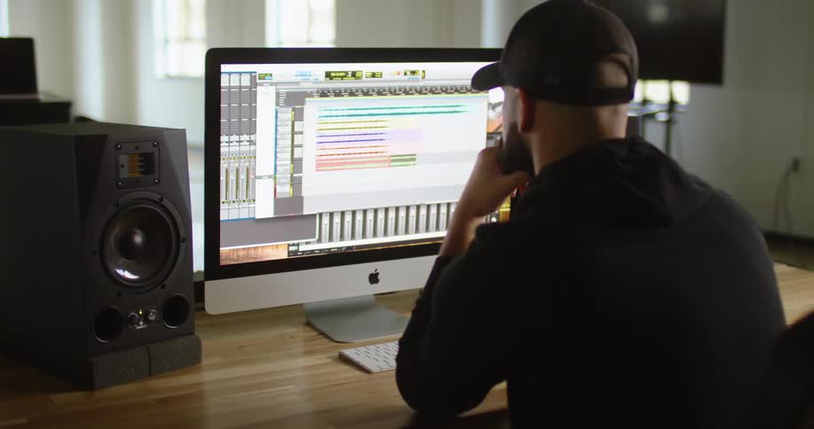 A man looks over a program on his computer monitor