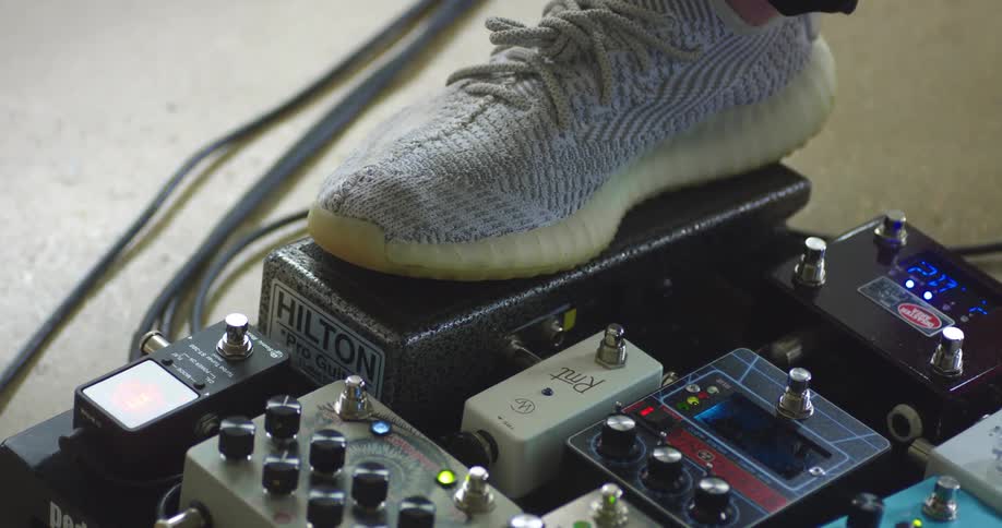 A musician pushing on a foot petal