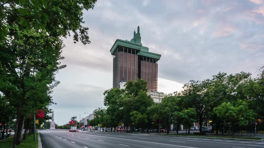 Traffic blurs through a busy city intersection