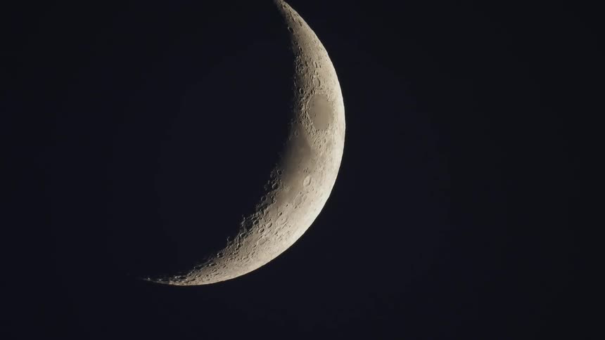 The moon with craters with the dark sky in the background